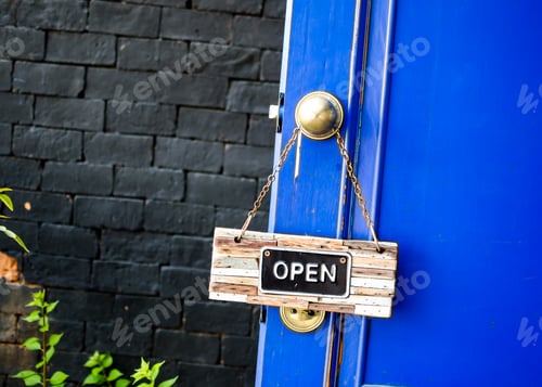 Preview: open label hanging on blue door in garden