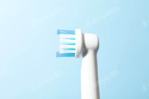 Preview: Electric toothbrush on light blue background, close up