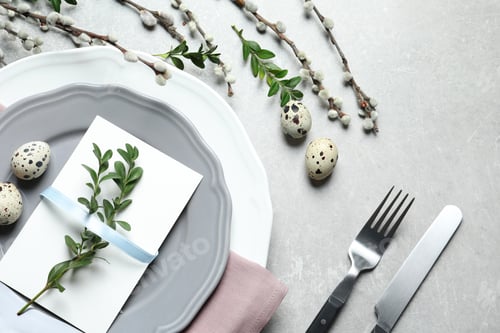 Preview: Festive Easter table setting with quail eggs on color background, flat lay