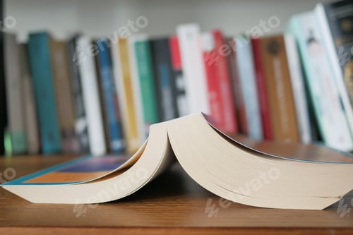 Preview: stack of books on wooden table