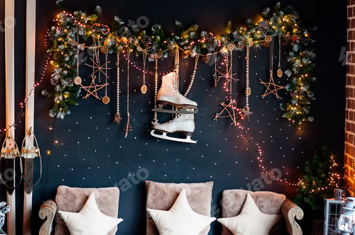 Preview: Festive garland of pine needles, dried oranges, ice skates hangs against a dark blue background.