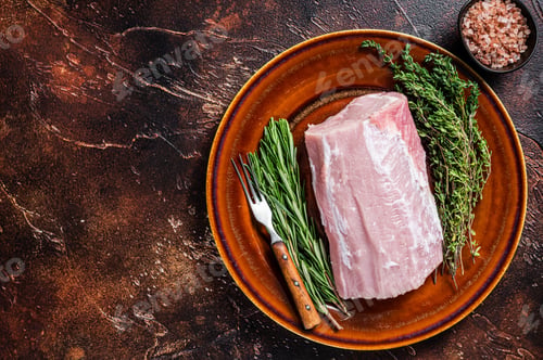 Vista previa: Fresh Raw pork loin meat with thyme and rosemary on rustic plate. Dark background