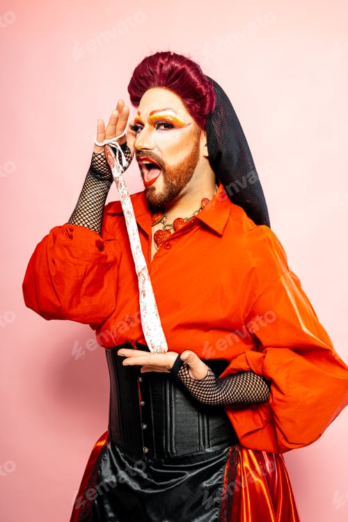Preview: Crossdresser Man in Orange Shirt and Black Skirt Holding a Salami Sausage