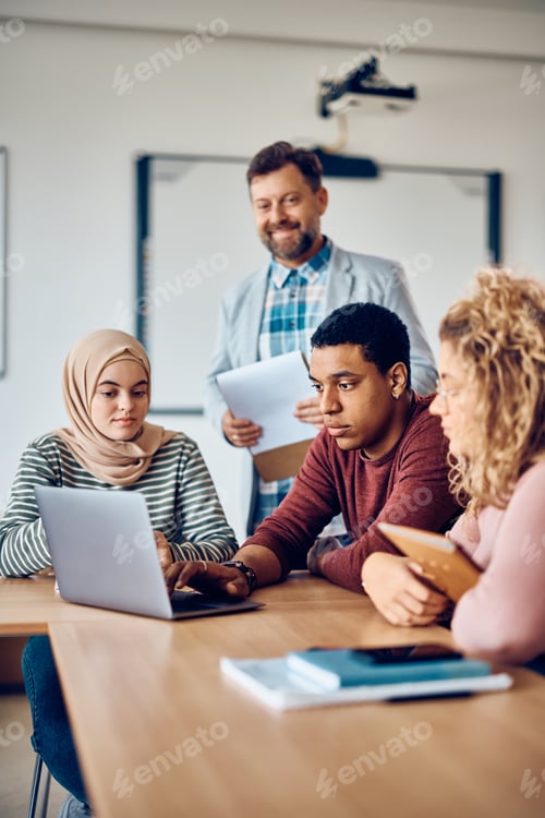 Preview: Multiracial group of students e-learning on laptop in the classroom at the university.