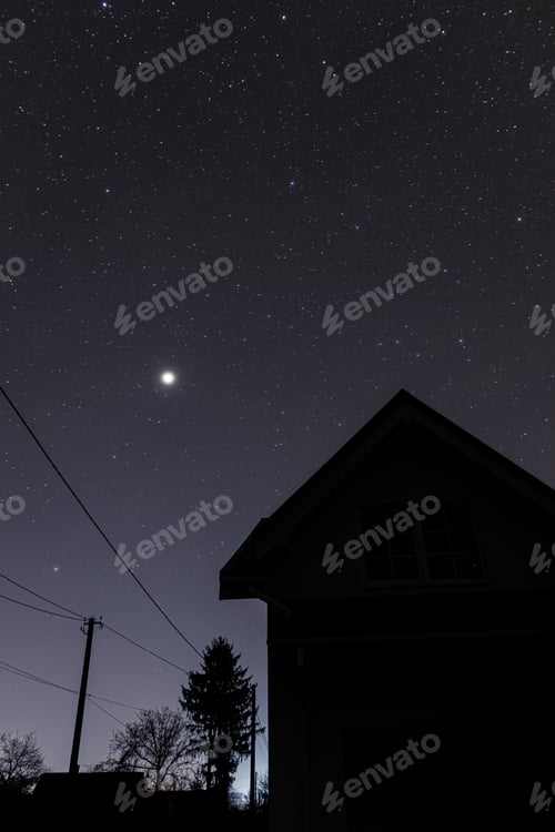 Preview: Amazing night sky with stars over modern farmhouse. Beautiful starry sky. Milky way galaxy