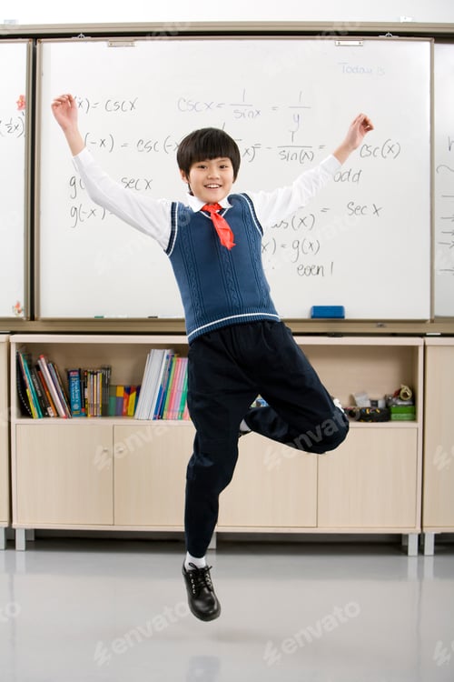 Preview: Young student jumping in front of whiteboard
