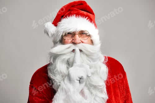Preview: Santa Claus standing on the grey background and showing quiet sign