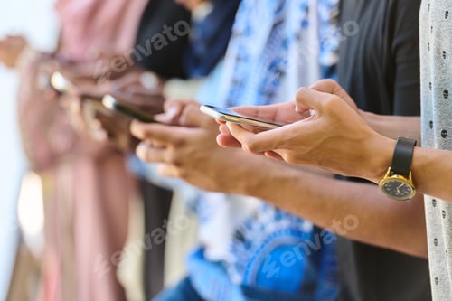 Preview: Diverse Teen Group Standing Together Against Wall Using Smartphones