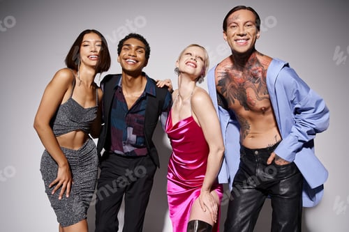 Preview: joyous multiethnic men and women in stylish attire on grey backdrop celebrating Happy New Year, 2024