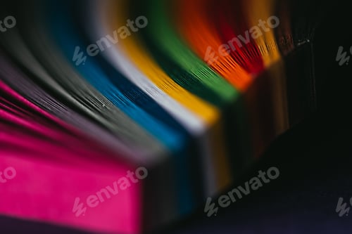 Preview: close up view of connected colored quilling paper on dark surface