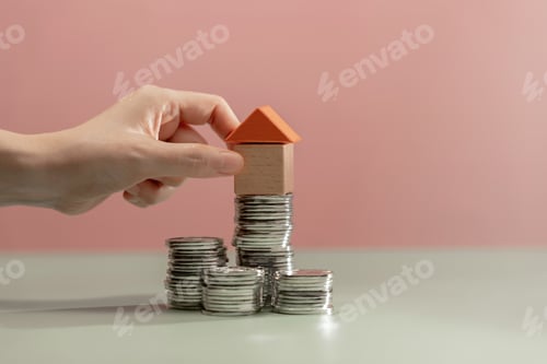 Preview: Toy Home Atop Stacks of Coins for Savings