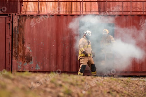 Preview: Firefighters in full protective gear participate in a training exercise outside