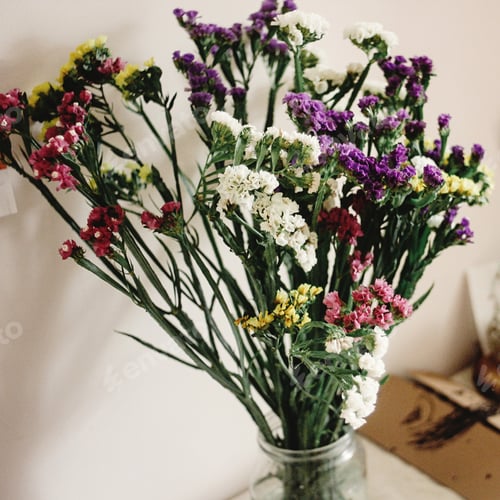 Preview: colorful amazing wildflowers in vase on background of rustic room