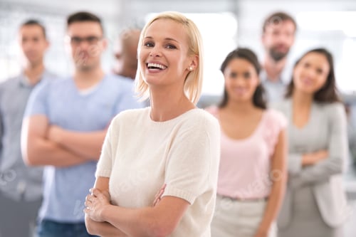 Preview: Shot of a smiling businesswoman standing in front of her coworkers
