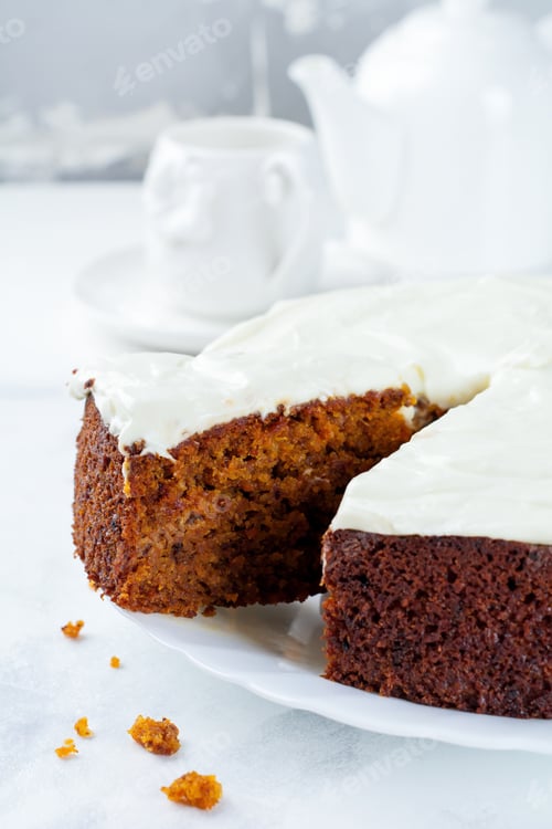 Preview: Carrot cake with cream on light background. Selective focus