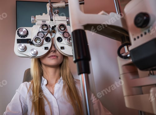 Preview: Woman Is checking her sight at optician cabinet