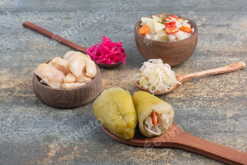 Preview: Three spoons of cabbage with wooden bowl of salty vegetables