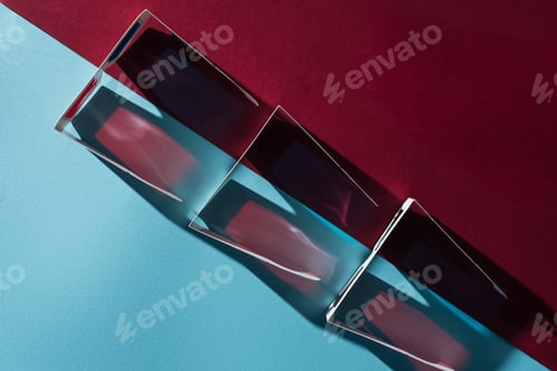Preview: top view of cardboard 3d glasses in row with shadows on blue and bordo background