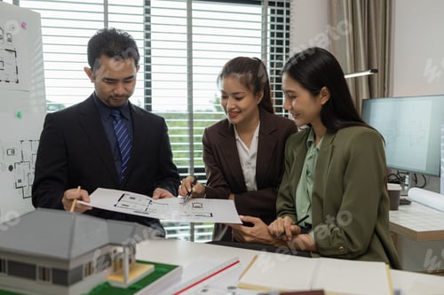 Preview: Architects work with engineers and contractors in the office to check the accuracy of the first draf
