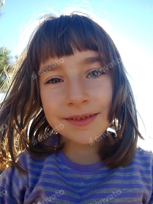 Preview: Portrait of a beautiful smiling young girl in the outdoors