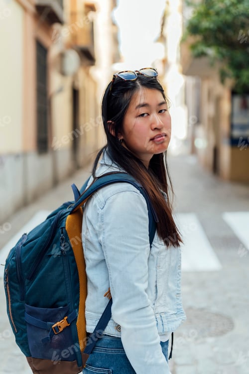 Preview: Serious woman with backpack in the city