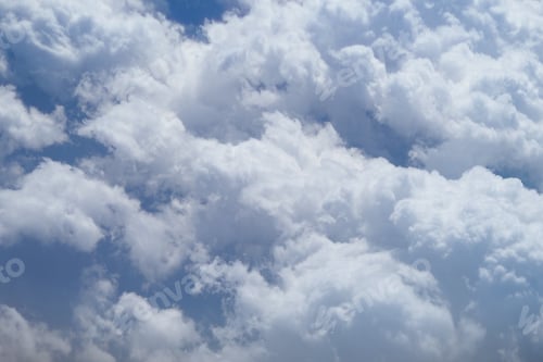 Preview: Fluffy white clouds decorate the blue sky during a sunny day
