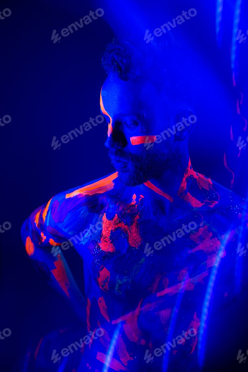 Preview: Portrait of a man with ultraviolet makeup and neon light in cyberpunk style.