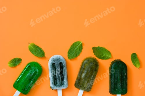 Preview: Refreshing mint popsicles with fresh mint leaves on orange background