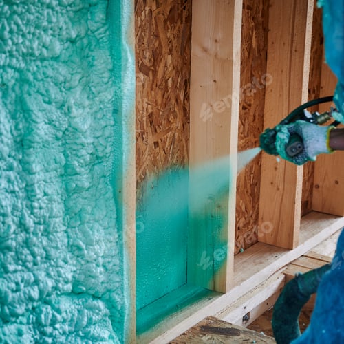 Preview: Worker spraying polyurethane foam for insulating wooden frame house.
