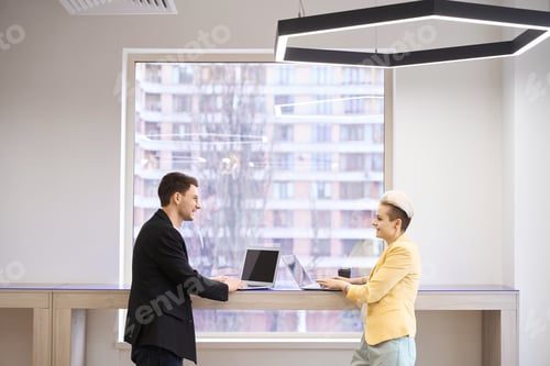 Preview: Partners discussing work strategy at open scape office