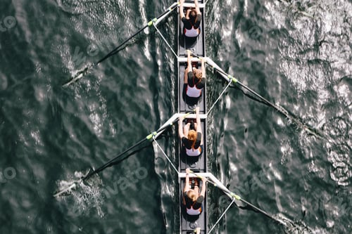Preview: Overhead view of female crew racers rowing in an octuple racing shell, an eights team.