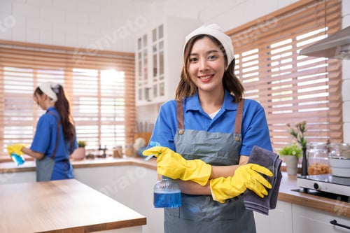 Preview: Portrait of Asian cleaning service woman worker working in the kitchen.