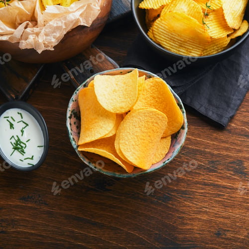 Preview: Potato corrugatedchips. Fast food. Crispy potato chips ceramic black bowl with sour cream sauce and