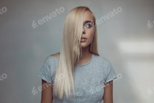 Preview: Pretty blonde woman posing in light room