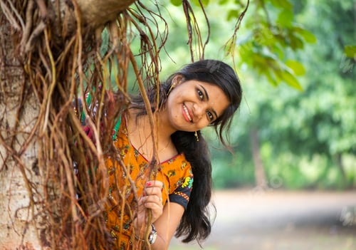 Preview: Beautiful girl between nature full of branches of tree.