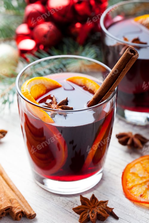 Preview: Mulled Red Wine with Spices, Orange Slices on New year and Christmas Background.