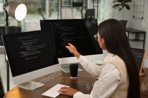 Preview: Programmer working at desk in modern office