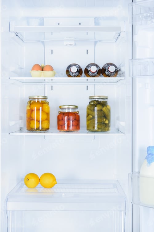 Preview: lemons, preserved vegetables and eggs in fridge