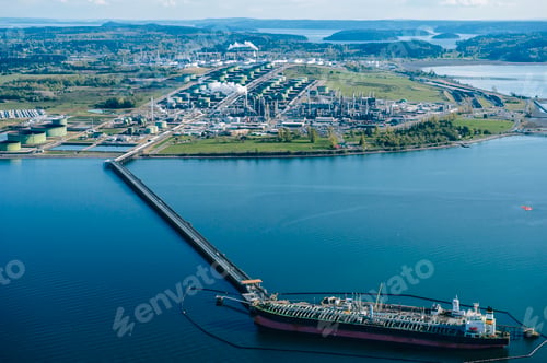 Preview: High angle view of oil transfer between coastal oil refinery and oil tanker
