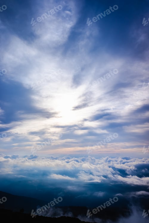 Preview: Sunlight Peeks Through Clouds Above Mountain Range