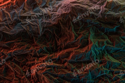 Preview: top view of crumpled textured paper with multicolored lighting in darkness