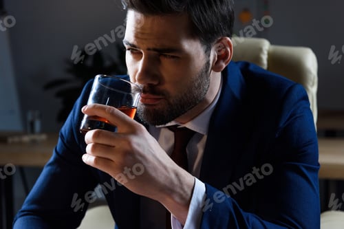 Preview: portrait of businessman drinking whiskey and looking away
