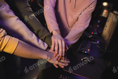 Preview: Cropped view of multiethnic team holding hands in cyber club