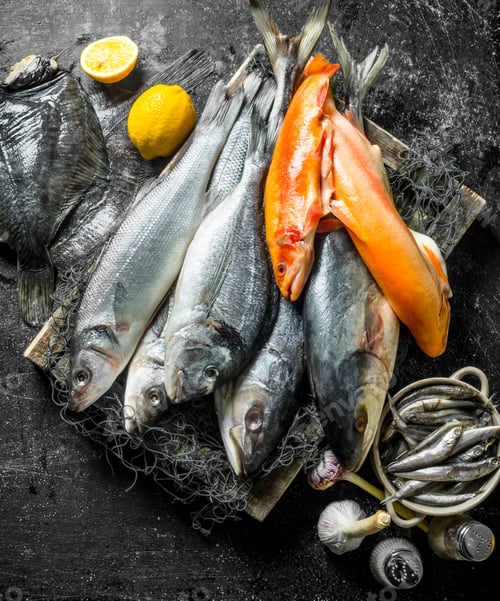 Preview: Fresh raw fish on tray with garlic and spices.