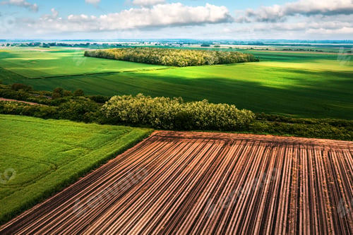 Preview: Beautiful cultivated countryside landscape in spring, aerial shot from drone pov