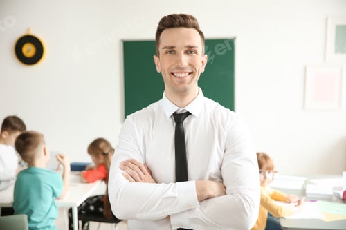 Preview: Young teacher in classroom at school
