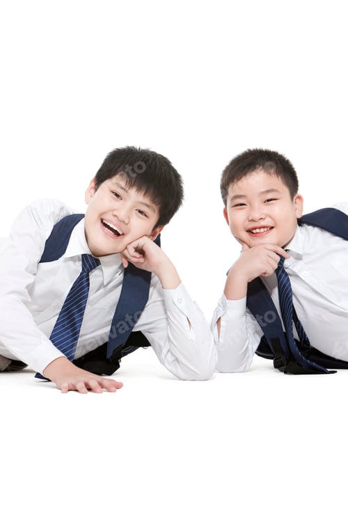 Preview: Portrait of primary school friends lying on floor with hand on chin happily
