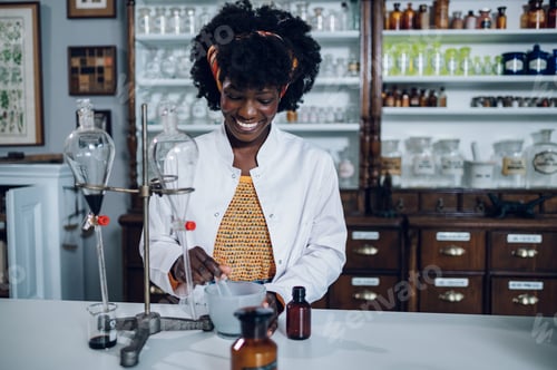 Preview: African American apothecary technician is and mixing the medicine ingredients