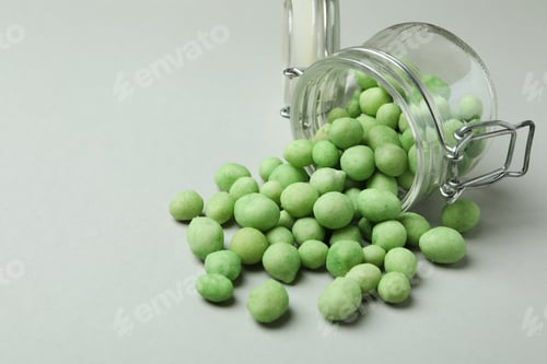 Preview: Glass jar with wasabi nuts on gray background