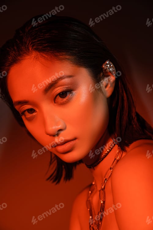 Preview: portrait of mesmerizing asian woman with short hair and wet hairstyle posing with trendy cuff